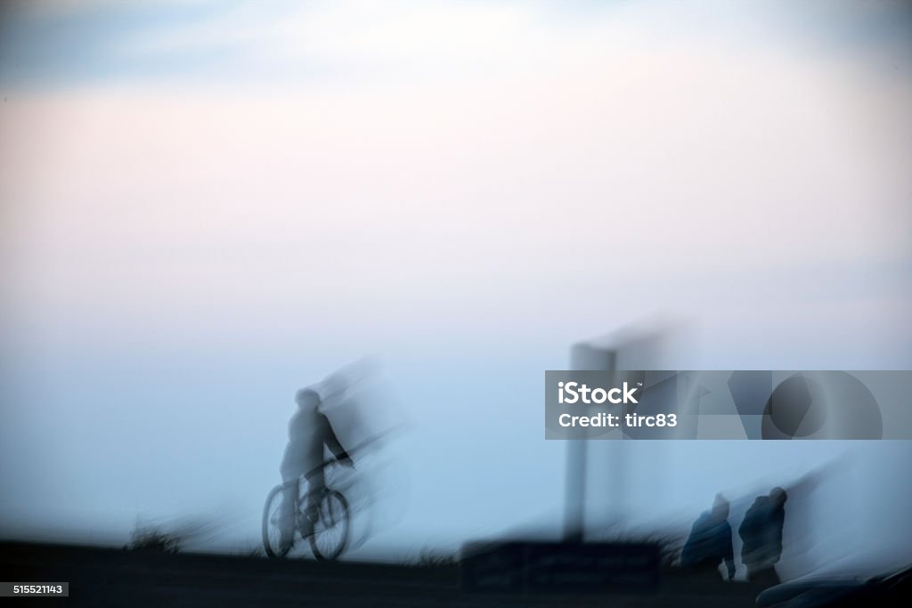 Motion blur of cyclists and walkers at dusk Blue Stock Photo