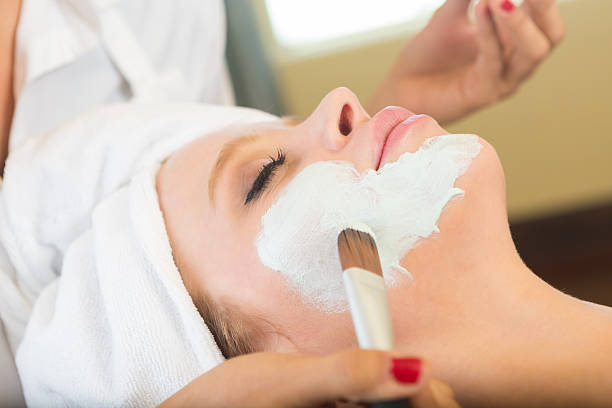 istock Day spa customer relaxing during facial from esthetician 515521355