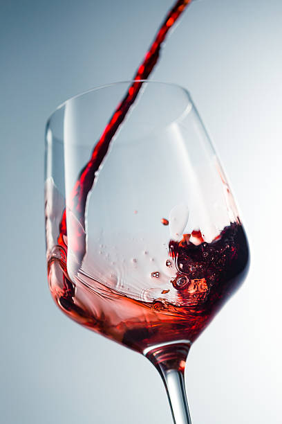 istock Red wine pouring in glass 515521366
