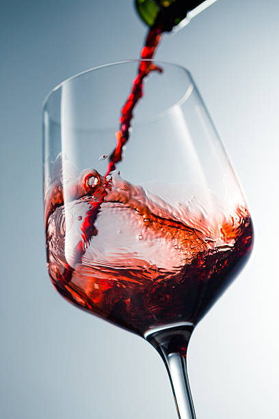 istock Red wine pouring in glass 515521766