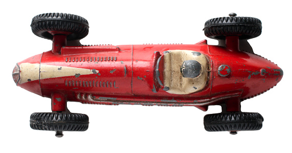 Red Maserati racing car top view / looking down. Dinky Toy number 23N. The 23N was made in 1953 and 1954. Dinky Toys are diecast metal models made by Meccano Ltd in the UK between 1935 and 1979. The original rubber tyres were grey. Nowadays (2016) there is an industry in producing replacement tyres, and new boxes for old Dinky Toys can be bought for nearly ú5. each.