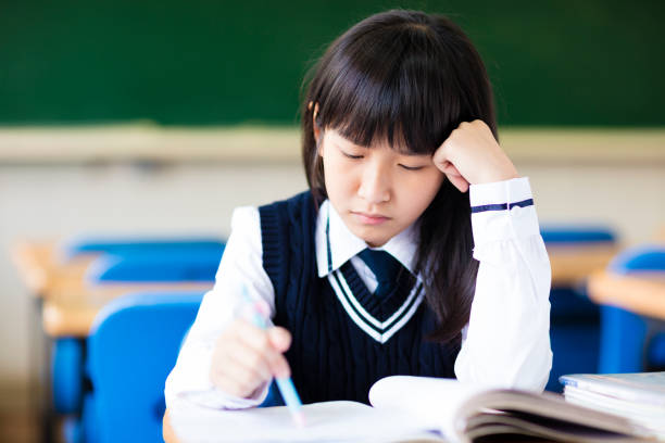 Stressed Student Of High School Sitting in classroom