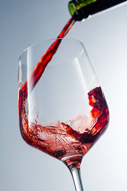 istock Red wine pouring in glass 515522126