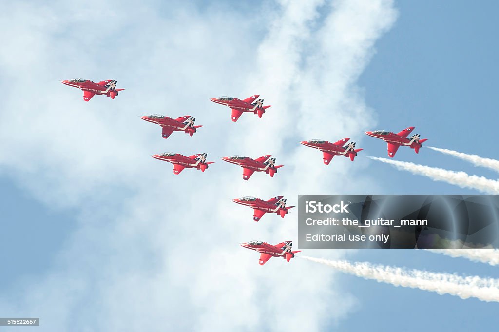 Red Arrows Farnborough, UK - July 18, 2014: The Red Arrows formation flight display team leaving smoke trails in the sky over Farnborough, UK during a display event. Aerobatics Stock Photo