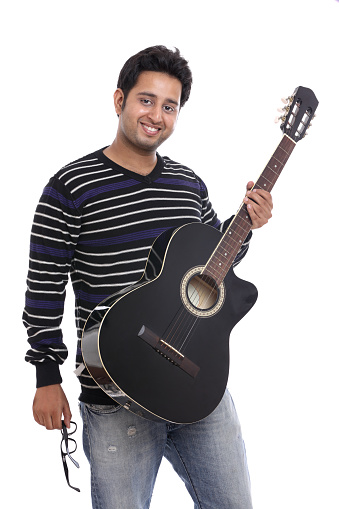 
An Indian guitar player posing with guitar on white background.