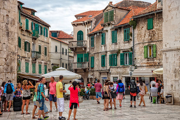 Split, Croatia - July 21, 2014: Tourists walk in the Old Town on a cloudy summer day in Split, Croatia.