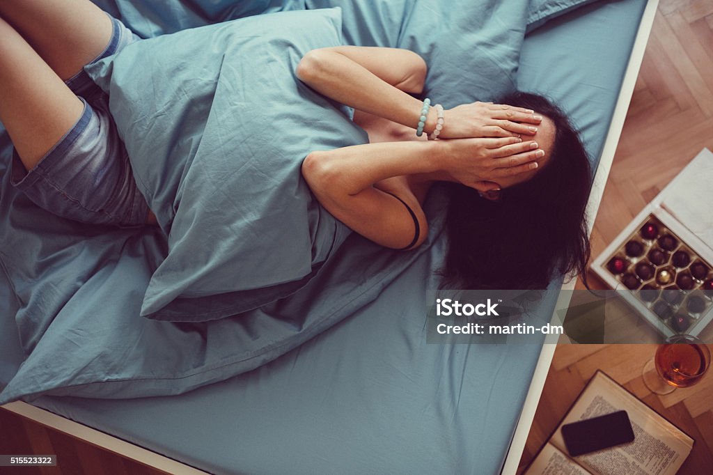 Chica llanto en la cama - Foto de stock de Mujeres libre de derechos