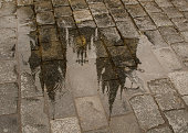 Church of Mother of God before Týn roof reflection in puddle
