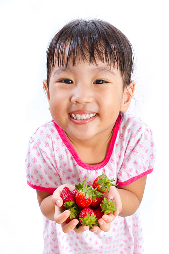 Asian Little Chinese Girl Holding Strawberry isolated on White Background