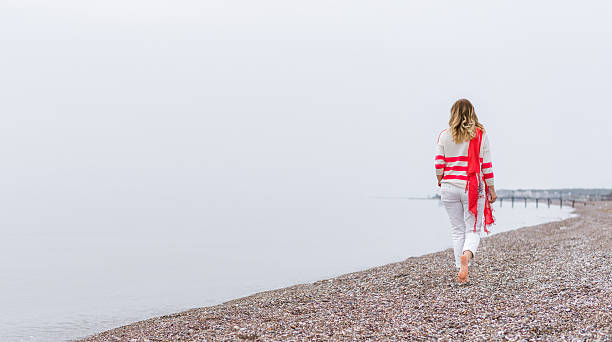 istock Young woman walking  at the beach 515524924