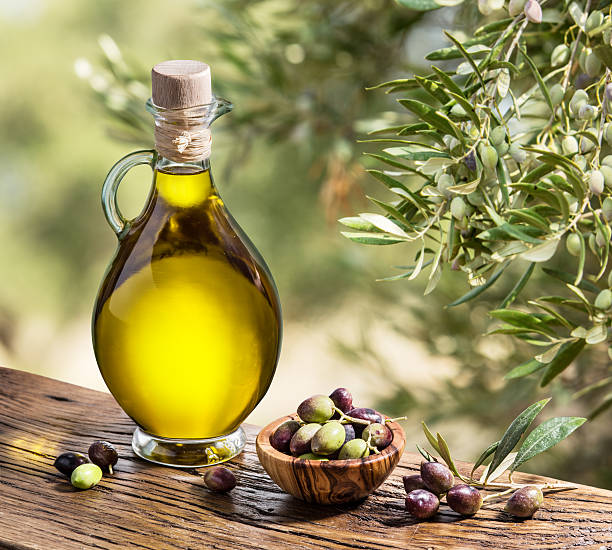 istock Olive oil and berries on the wooden table. 515525308