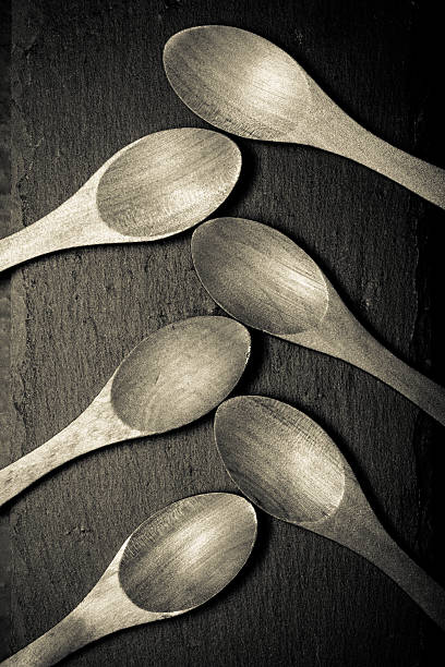 istock Wooden spoons on a plate of slate 515526482