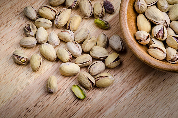 istock roasted and salted pistachios on wooden background.. 515526918