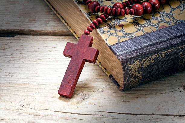 istock catholic wooden rosary beads with cross on an old book 515526948