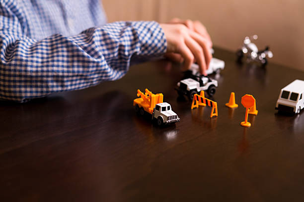 istock Boy's hand moves toy jeep. 515526982