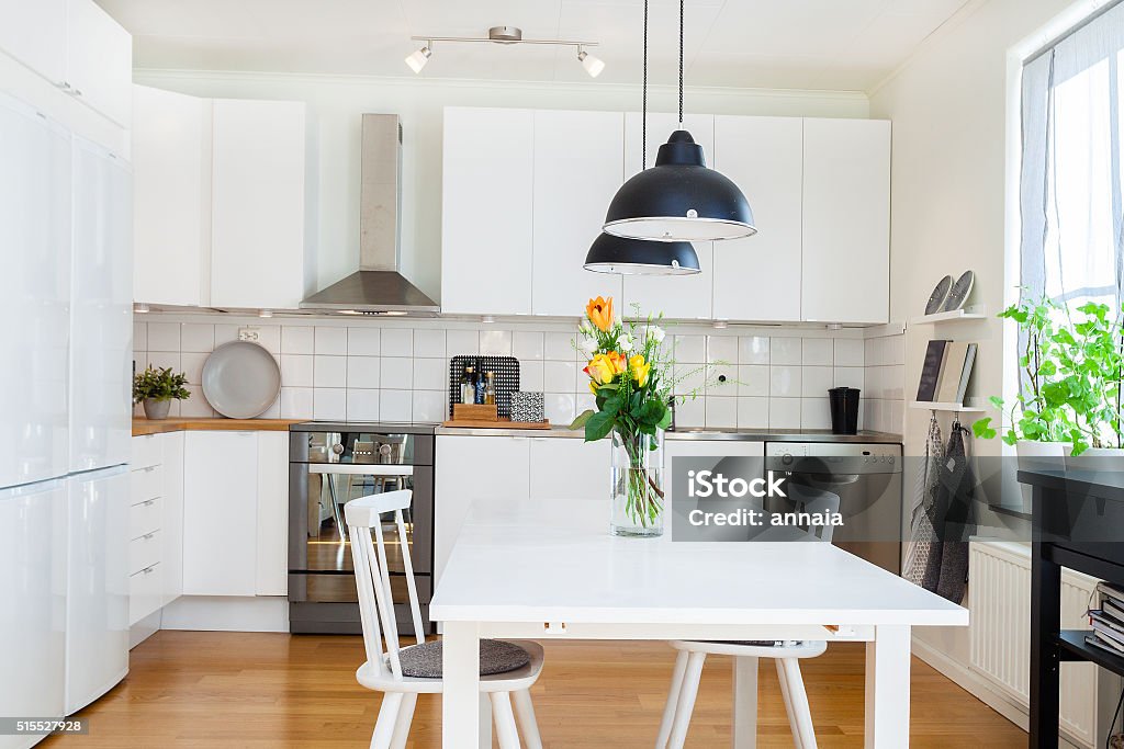 fancy kitchen interior fancy modern kitchen interior with a bouquet of roses on the kitchen-table Kitchen Stock Photo