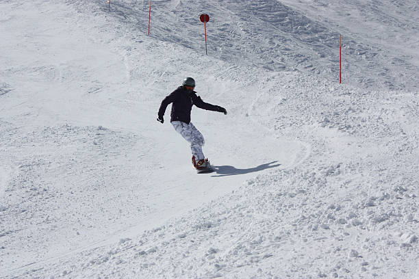 istock Young snowboarder woman sliding downhill. 515531976