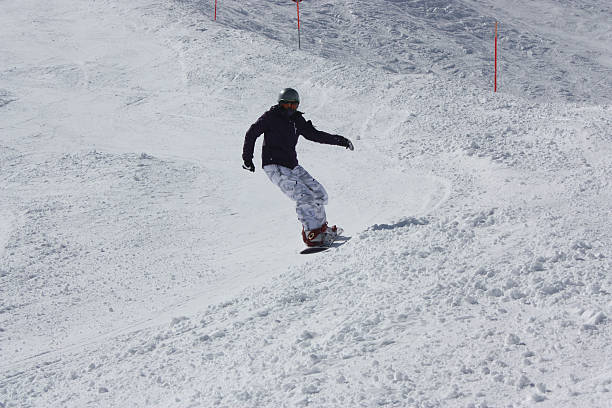 istock Young snowboarder woman sliding downhill. 515532036
