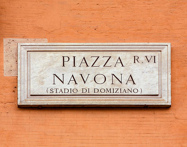 istock Piazza Navona sign on orange colored wall in Rome, Italy 515532350