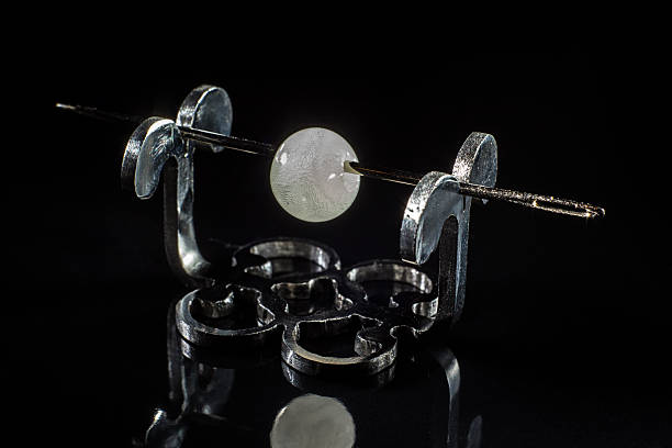 istock White glass bead with bubbles on stand 515532396