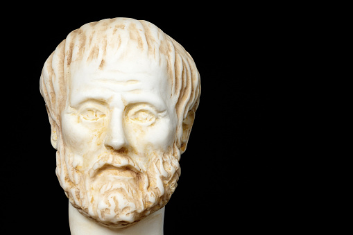 White marble bust of the greek philosopher Aristotle, isolated on black background