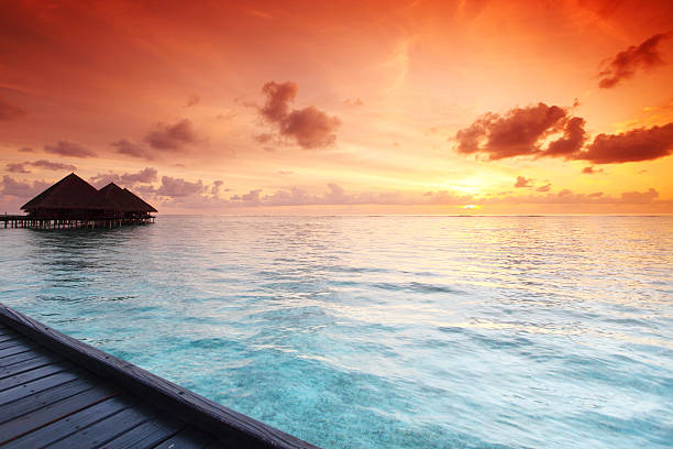 istock maldivian houses on sunrise 515547323