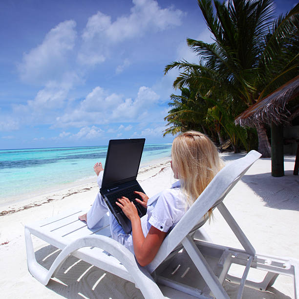istock tropical business woman with laptop 515547625