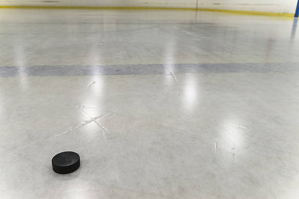 istock Hockey Puck on Ice Rink 515550021