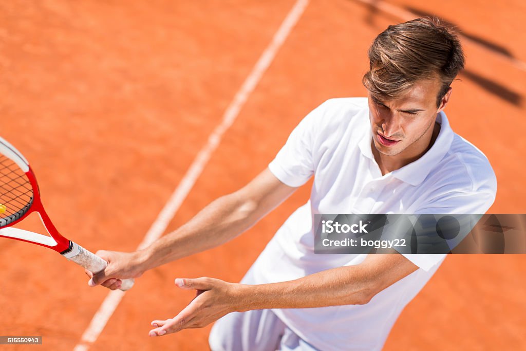 Young man playing tennis Activity Stock Photo