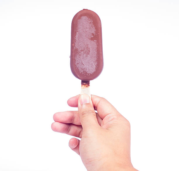 istock Young man holding chocolate popsicle, isolated on white backgrou 515551447