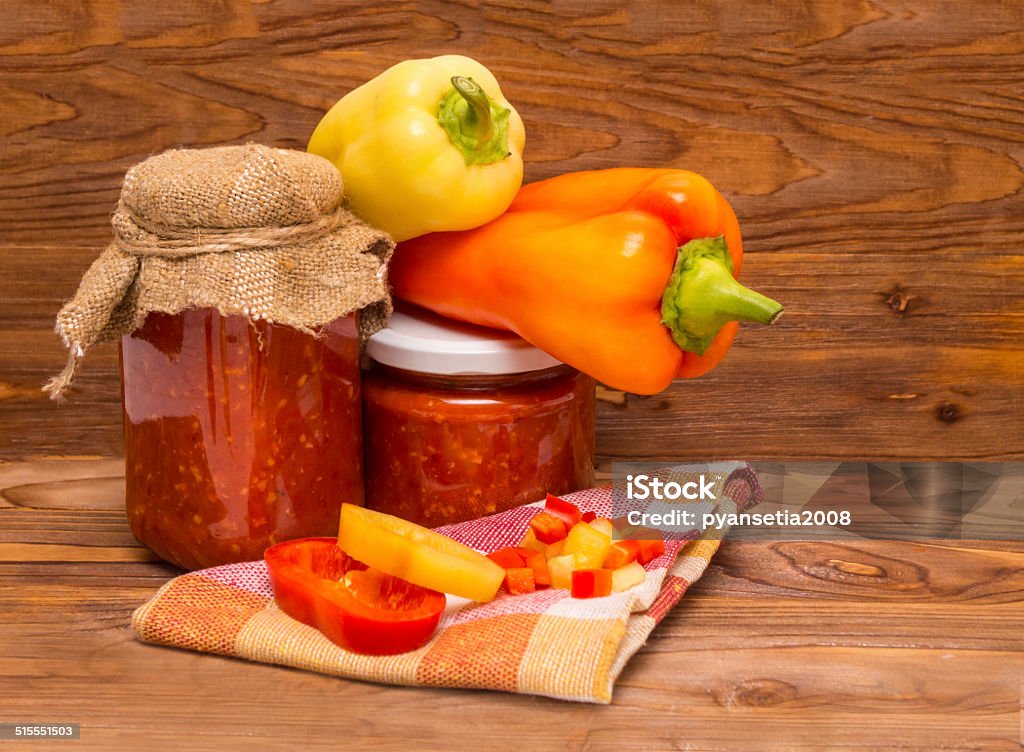 Sweet pepper. Assortment of sweet pepper and sauce with him on a wooden table. Arrangement Stock Photo