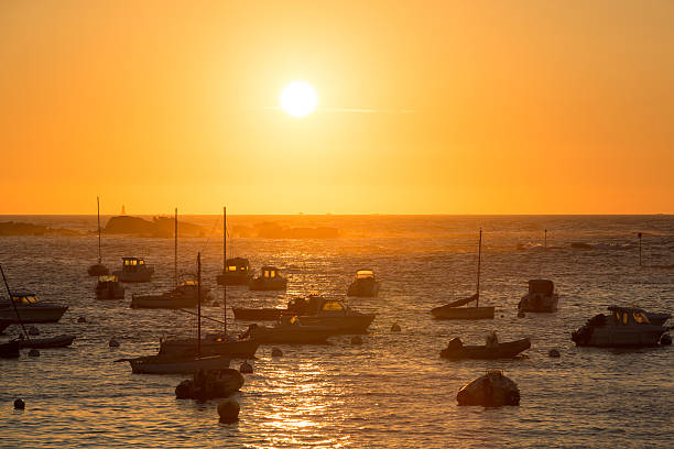 Sunset on the harbour of Tregastel with (between Perros-Guirec and Pleumeur-Bodou, Brittany, France). The Pink Granite Coast.