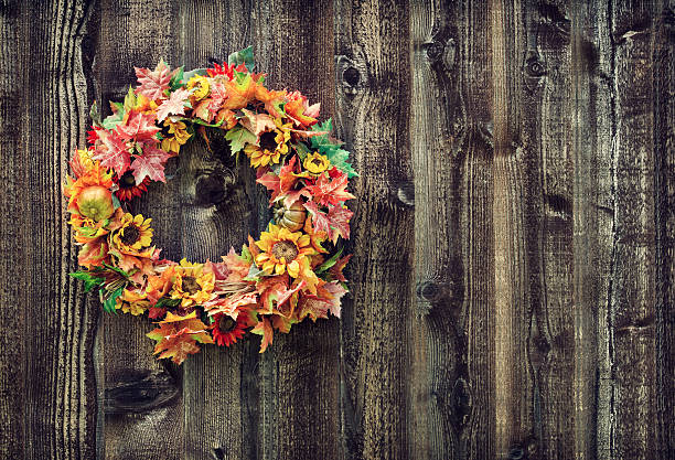 istock Autumn flower wreath against wood planks 515553369