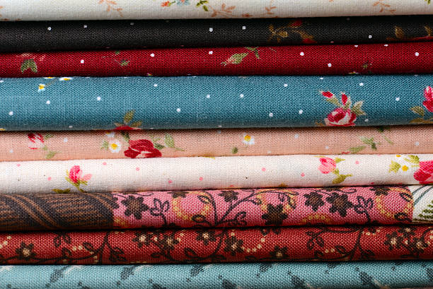 istock heap of cloth fabrics on wooden table 515553915
