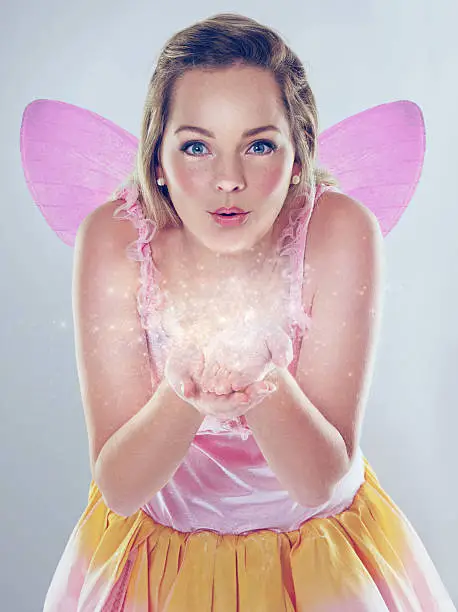 A cropped shot of a cute fairy dressed in pink