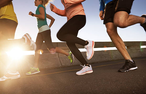 Cropped shot of a diverse group of runners on a road