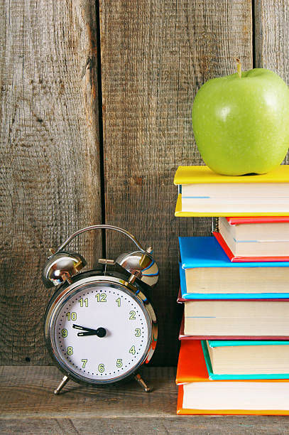 istock Alarm clock, green apple and books. 515581879