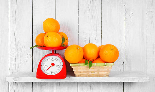 istock Orange on scales and in a basket 515582191