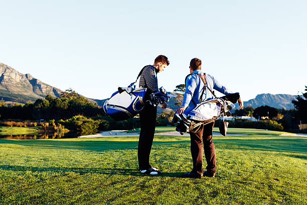 istock Two young men prepare to play golf on idyllic course 515582907