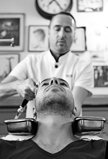 istock barber washing hair of customer 515582999