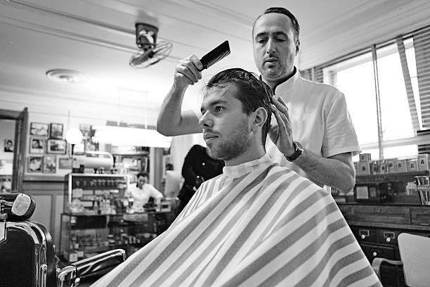 istock barber working with customer at barbershop 515583021