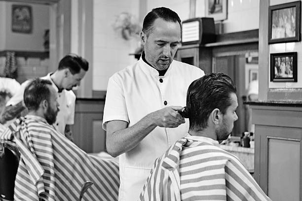 istock barber working with customer at barbershop 515583031