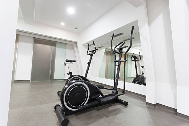 istock Elliptical trainer and bike in exercise room 515583327