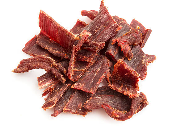 istock Pile of beef jerky with a white background 515583425