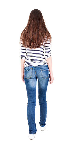 istock back view of walking  woman in jeans 515584113