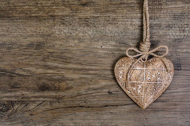 istock Wooden heart on vintage oak background, text space 515584309