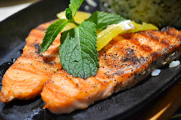 istock Two grilled salmon steaks with lemon and mint herb 515584489