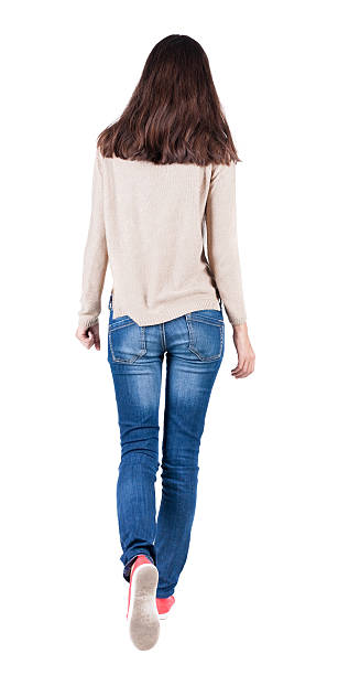 istock back view of walking  woman in jeans . 515585423