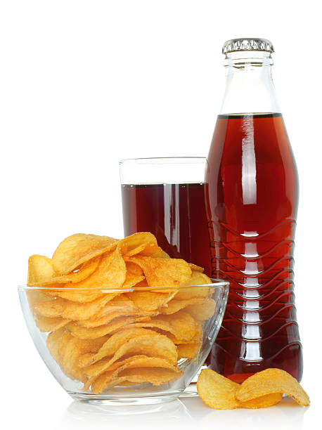 Bottle and glass of cola with potato chips