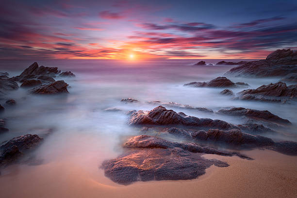 istock Waves and rocks in motion blur on coastline at dawn 515592486